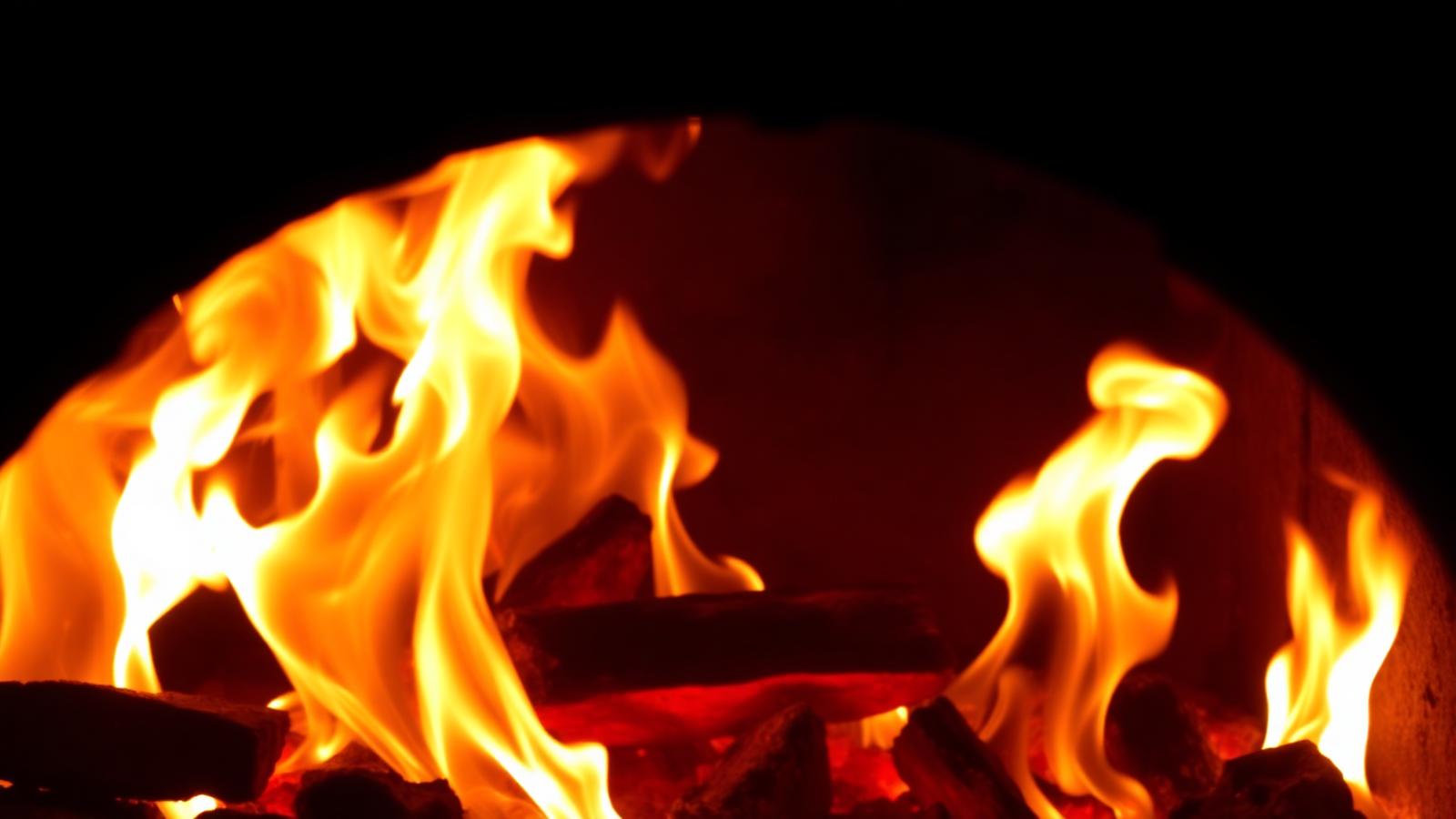 Roaring flames inside a wood-fired oven